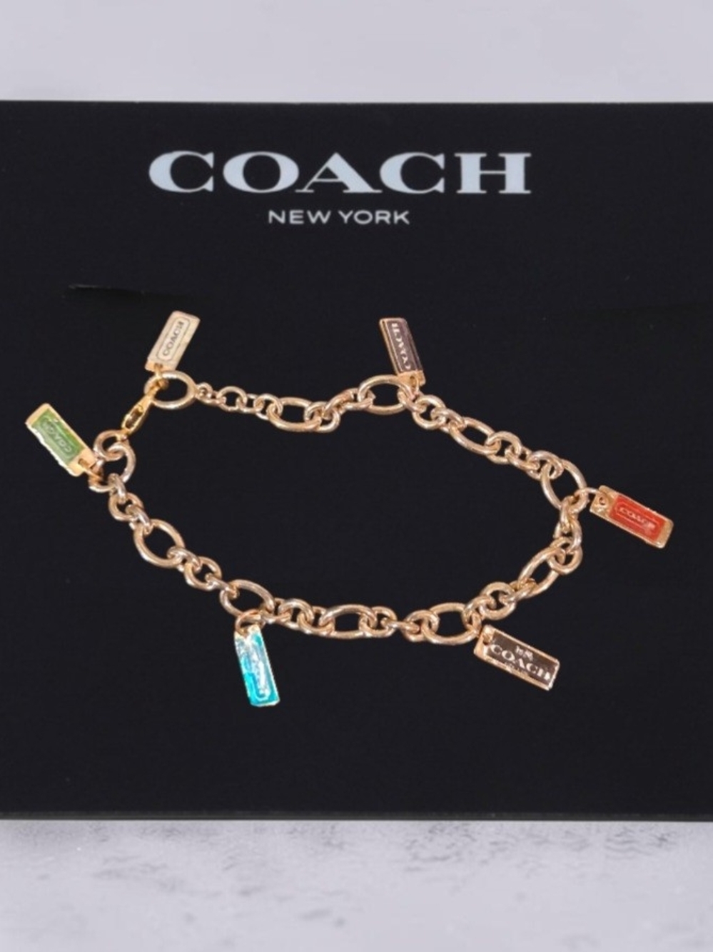 Coach Gold-Tone Charm Link Bracelet with Multicolor Enamel Tags